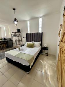 a bedroom with a large bed in a room at Angel's Cottage Unit 1 in Paarl