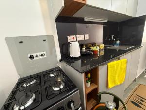 a small kitchen with a stove and a counter at Shooting Stars Homes in Gatunga