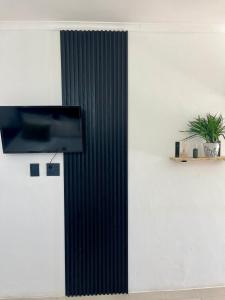 a wall with a flat screen tv on a wall at Angel's Cottage Unit 1 in Paarl