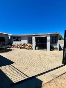 a house with a brick driveway in front of it at Angel's Cottage Unit 1 in Paarl