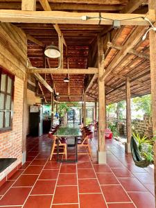 a dining room with a table and chairs on a patio at An's House - Đóng trên booking - LH trực tiếp in Phan Thiet