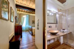 a bathroom with a sink and a glass shower at Il Tosco in Montepulciano +21 photos