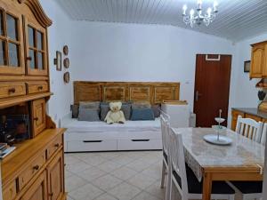 a bedroom with a bed with a teddy bear on it at Piknik Garden in Senta