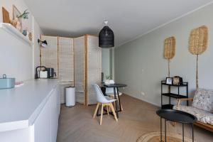 a kitchen and dining room with a table and chairs at DuoSuite Sand Vrouwenpolder in Vrouwenpolder
