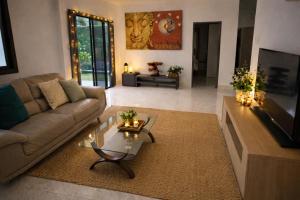 a living room with a couch and a coffee table at Villa Lilly in Rawai Beach