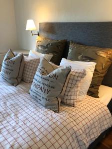 a bed with many pillows on top of it at Glimminge Bed & Breakfast in Simrishamn