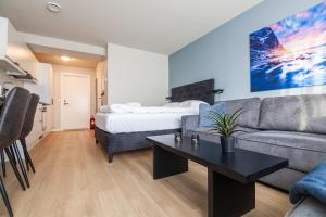 a living room with a couch and a bed at Lofoten Premium Suites in Leknes