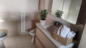 a bathroom with a sink and a toilet and a mirror at Maison Laurier in Fiumicino Airport