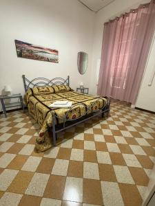 a bedroom with a bed and a checkered floor at Da Alfred in Naples