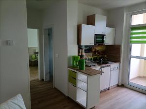 a kitchen with white cabinets and a counter top at Domizil NauNik in Naumburg
