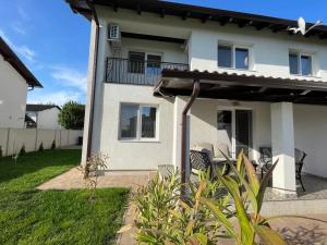 a white house with chairs and a balcony at Casa Carolina in Alba Iulia