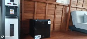 a small refrigerator in a room next to a chair at The Indah Cliff Sea View in Polilit