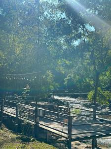 a group of benches sitting next to a river at Ban Kham Kee Homestay in Chiang Mai