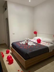 a bedroom with a bed with red balloons on the floor at LeRoccheRoom in Monreale