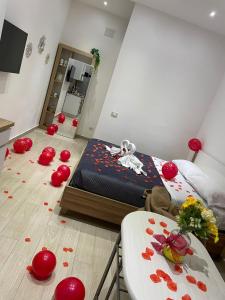 a bedroom with a bed with red flowers on the floor at LeRoccheRoom in Monreale