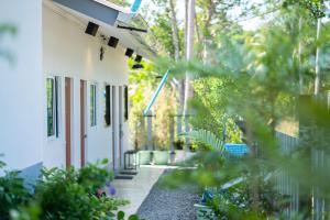 a porch of a house with plants and trees at Fix25House Koh Kood in Ban Khlong Mat