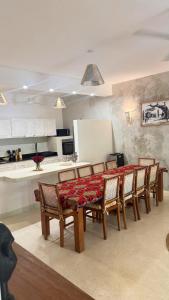 a dining room with a table and chairs and a kitchen at Villa Rebecca 1 at Paparemo Village in Watamu
