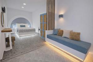 a bedroom with a bed and a desk in it at Papafotis Apartments & Suites in Alinda