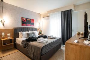 a hotel room with a bed and a desk with towels on it at ALEXANDRA Boutique Residence Seaside in Alexandroupoli