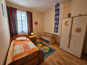 a bedroom with a bed and a crib in it at Ferienhaus Franzen 35679 in Uplengen +36 photos