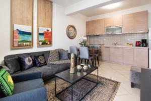 a living room with a couch and a table at ALEXANDRA Boutique Residence Seaside in Alexandroupoli