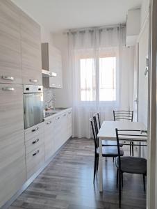 a kitchen with a table and a table and chairs at Sweet home in Novara