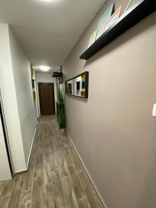 a hallway with white walls and wooden floors at Loft2 Apartman X ker in Budapest