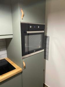 a kitchen with a stove and a refrigerator at Loft2 Apartman X ker in Budapest