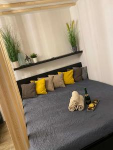 a bed with towels and a bottle of wine on it at Loft2 Apartman X ker in Budapest