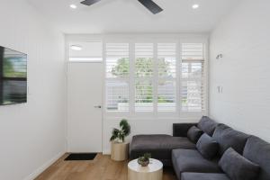 a living room with a couch and a window at Palm Beach Villas by Rockingham Apartments in Rockingham