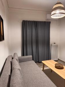 a living room with a couch and a table at Psani 50m2 apartment in Nafpaktos
