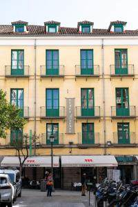 a large yellow building with windows on the side of it at Ateneo Puerta del Sol in Madrid