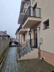 a building with stairs and balconies on a street at ApuLux Apartments in Alba Iulia