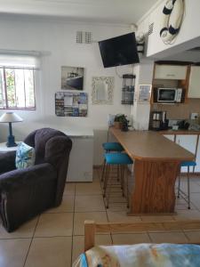 a living room with a couch and a table at Michelle's Cottage by the Sea in Port Shepstone