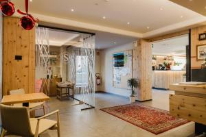 a living room with a table and a dining room at Hotel St. Michael in Livigno