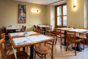 a dining room with wooden tables and chairs at Ateneo Puerta del Sol in Madrid