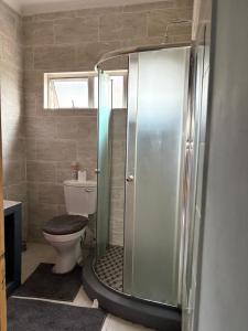 a bathroom with a shower and a toilet at Elephant Cove in Shakawe +19 photos