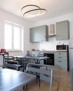 a kitchen with a dining room table and chairs at Guest house - L'amante e il marinaio in Fiumicino