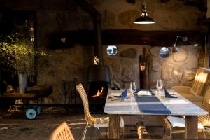 a table with chairs and a fireplace in a room at Lodge Norheim in Asahikawa