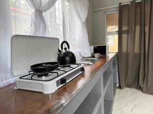 a tea kettle sitting on a stove in a kitchen at Elephant Cove in Shakawe