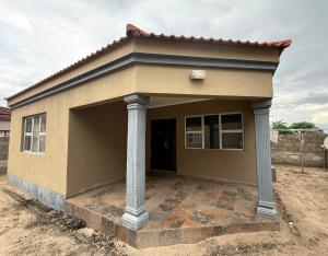 a small house with a porch with columns at Elephant Cove in Shakawe