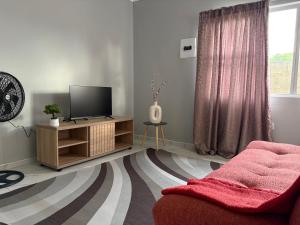 a living room with a tv and a couch at Elephant Cove in Shakawe