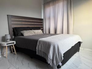 a bedroom with a large bed and a window at Elephant Cove in Shakawe