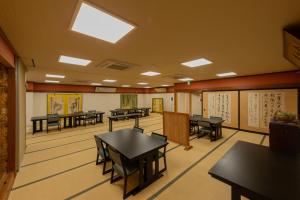 a dining room with tables and chairs in it at Fukumakan in Matsue