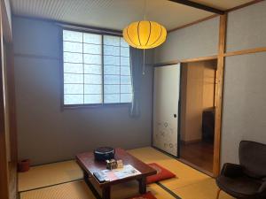 a living room with a table and a window at Fukumakan in Matsue +44 photos