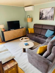 a living room with a couch and a table at Le lit de la Semois in Vresse-sur-Semois