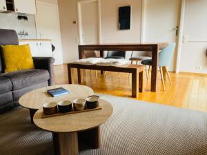 a living room with a couch and a table at Le lit de la Semois in Vresse-sur-Semois