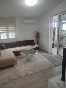a living room with a couch and a coffee table at Bar ,2 sobni stan ,Namaste ! in Bar
