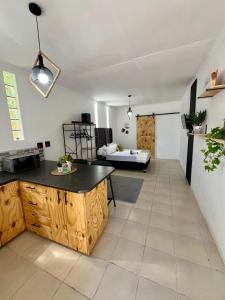 a kitchen and living room with a table and a couch at Angel's Cottage Unit 1 in Paarl