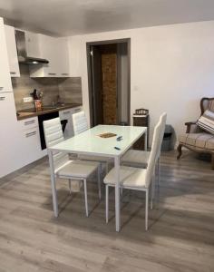 a white dining room table and chairs in a kitchen at Hôtel&Restaurant HDLV climatisées in Ornans +7 photos